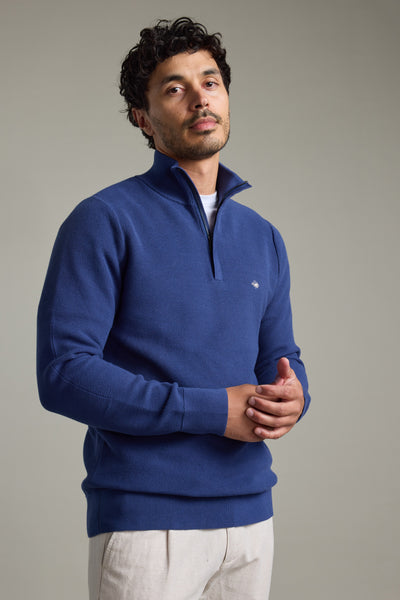 Man in a Barkers Gaston Cotton 1/4 Zip Sweater, standing against a plain background.