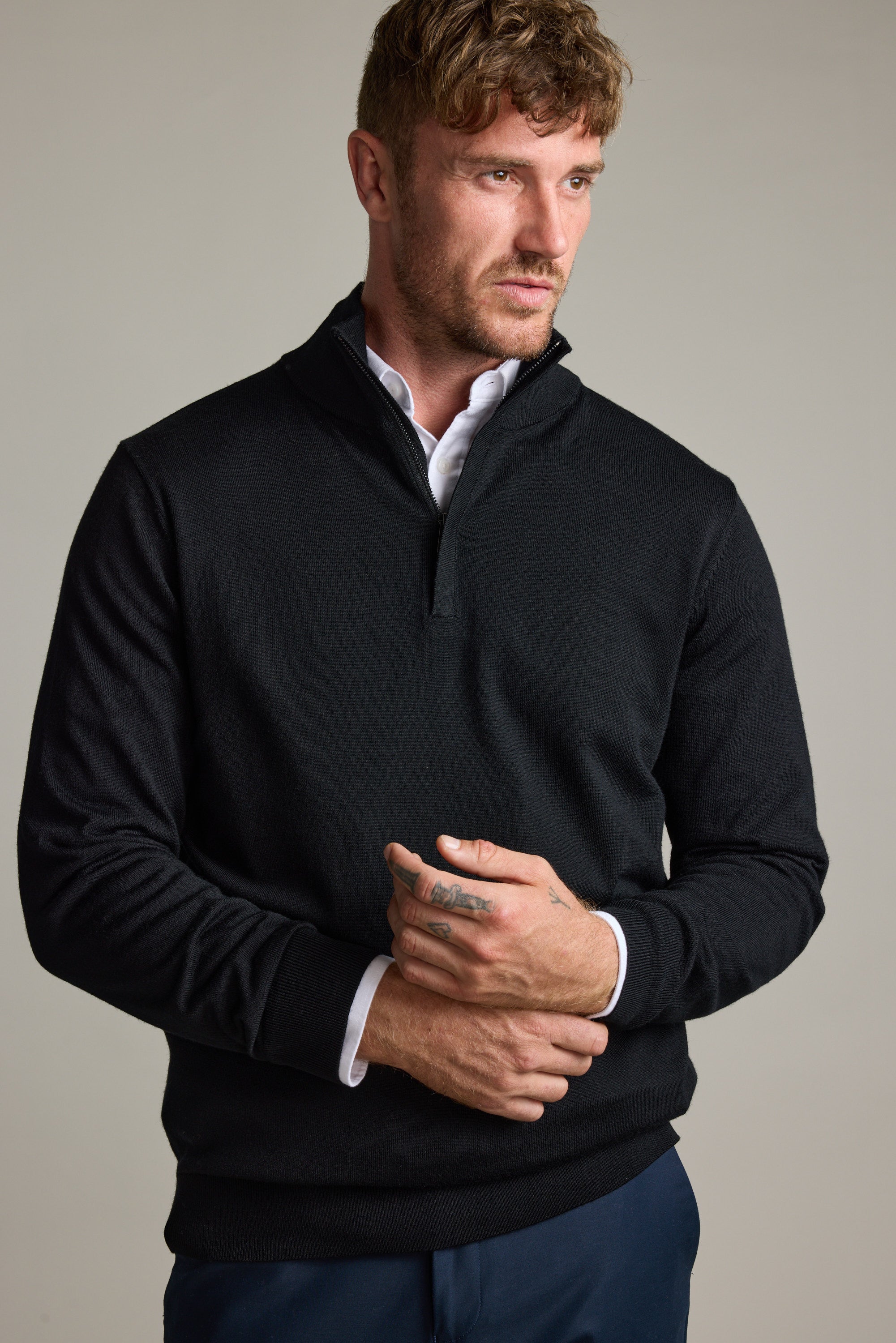Man in Barkers Skyland ZQRX Merino 1/4 Zip, looking to the side against a plain background.