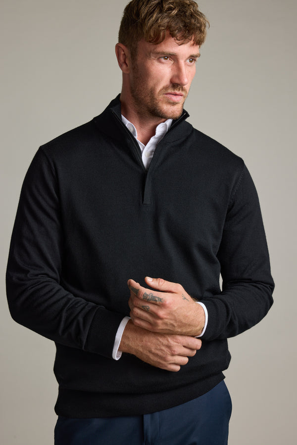 Man in Barkers Skyland ZQRX Merino 1/4 Zip, looking to the side against a plain background.