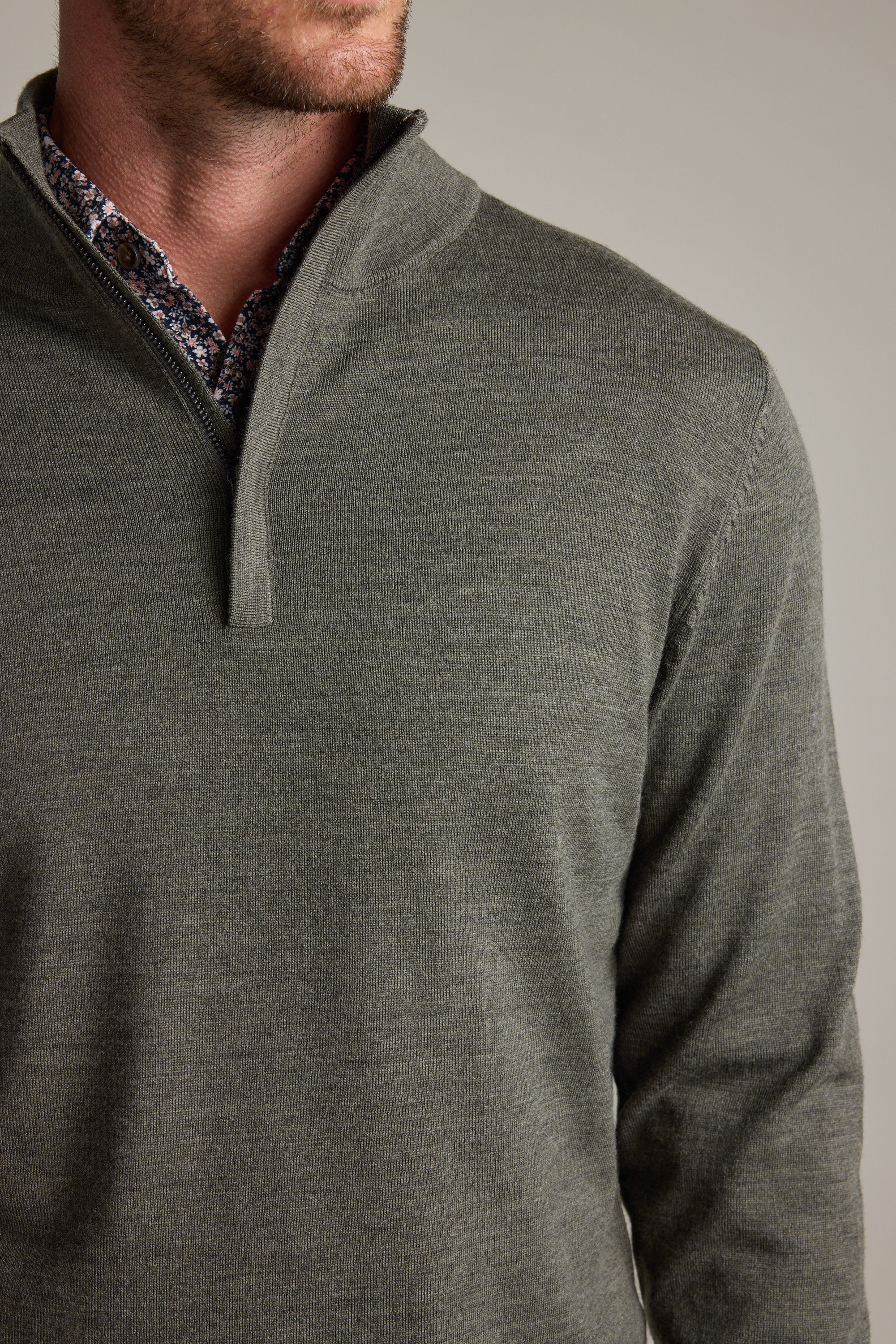 Man wearing a Barkers Skyland ZQRX Merino 1/4 Zip over a patterned dress shirt.