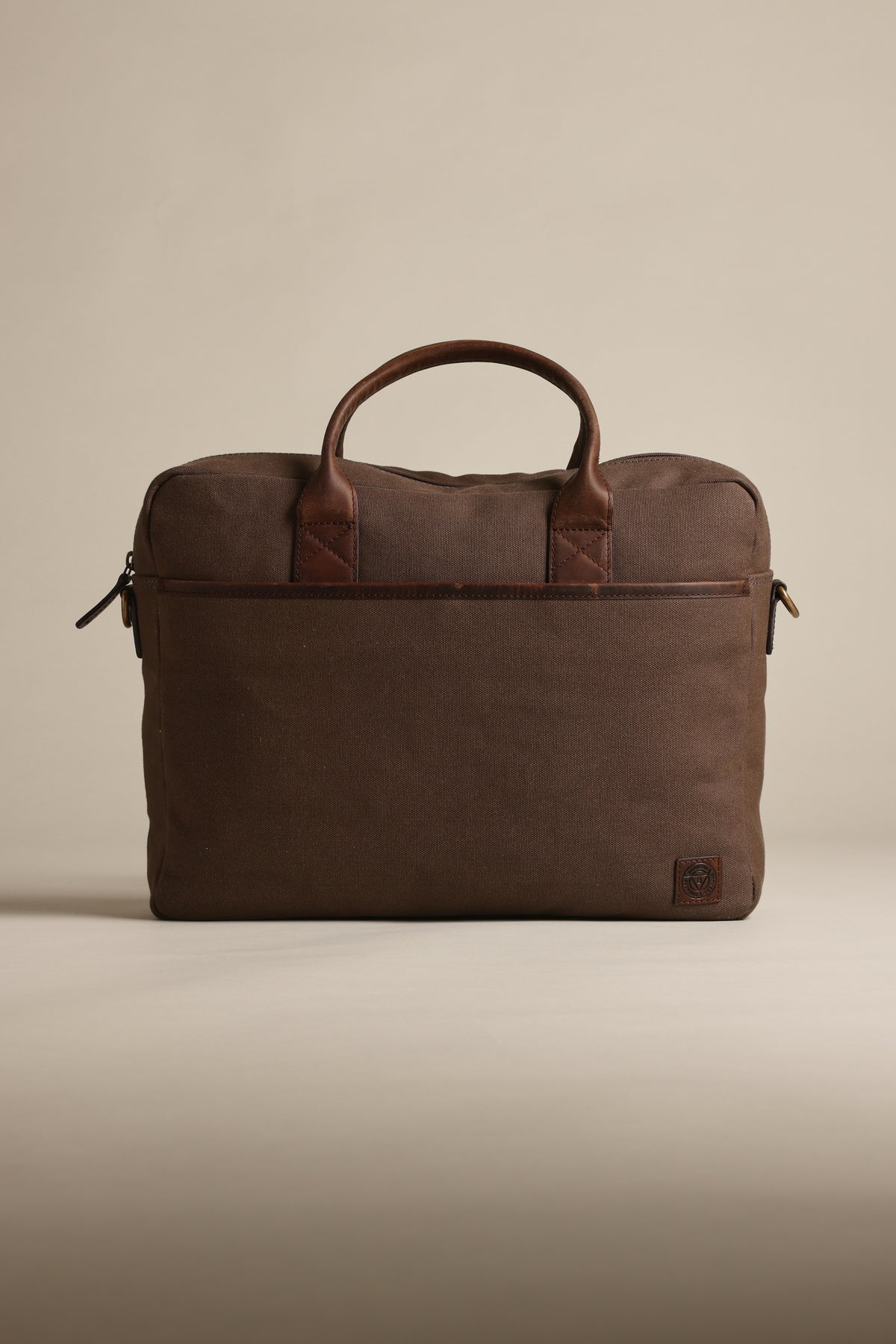Barkers Redford canvas laptop bag with leather handles on a plain beige background.