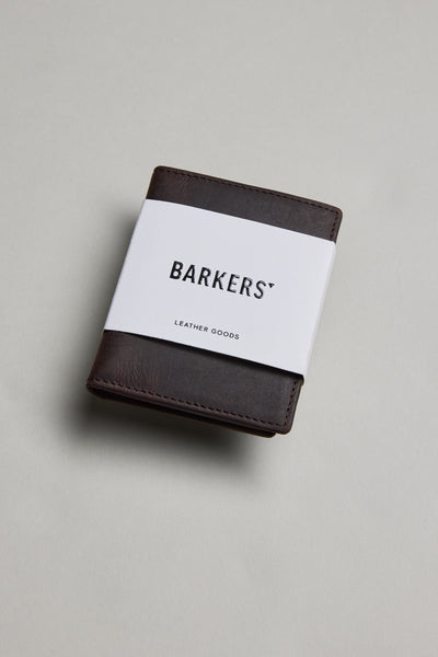 Marlin Leather Slim Wallet by Barkers, dark brown, with white band on gray surface.
