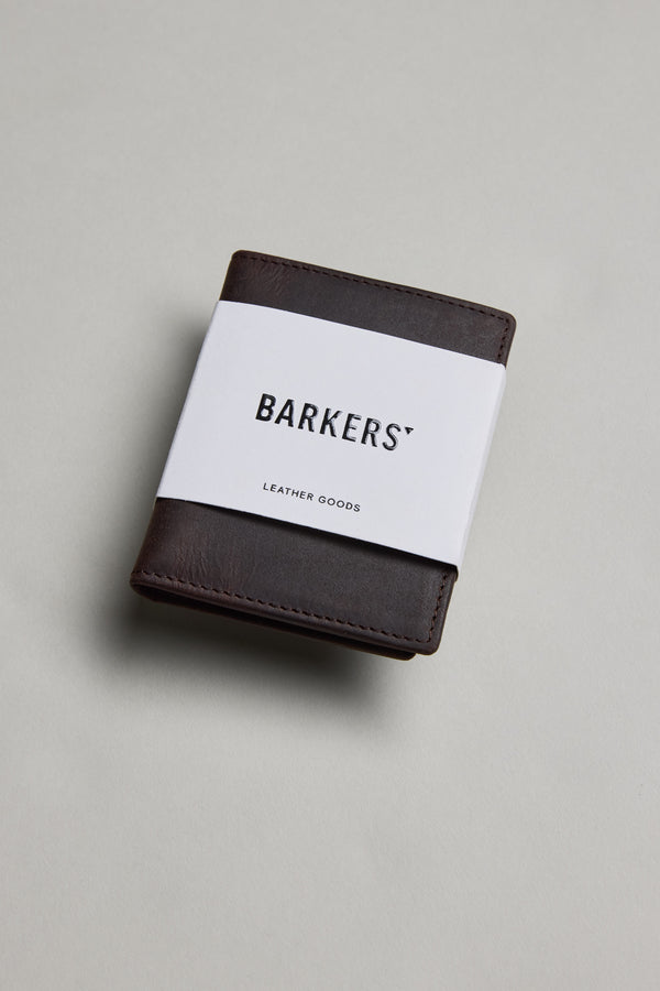 Marlin Leather Slim Wallet by Barkers, dark brown, with white band on gray surface.