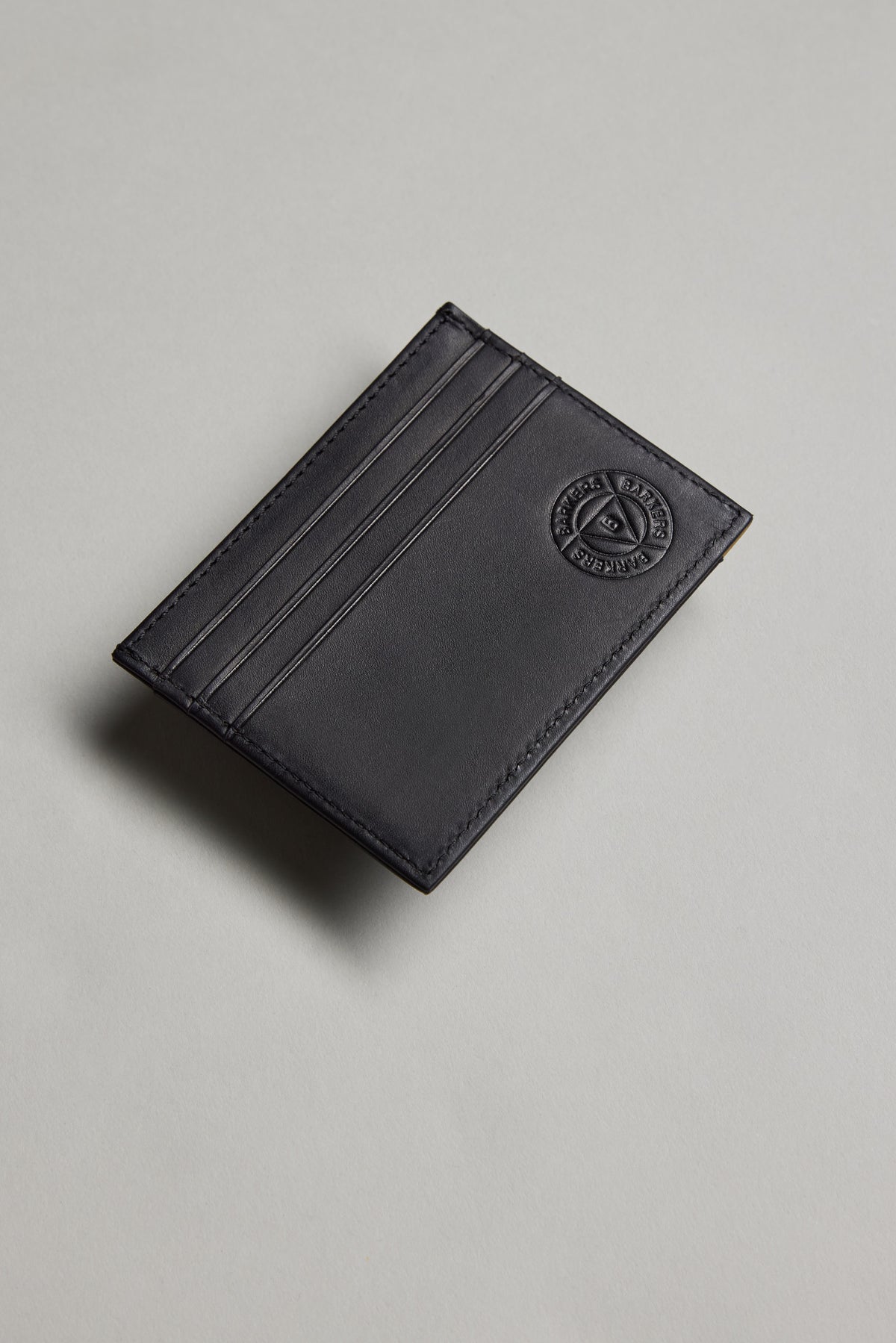 Barkers Taylor Leather Card Wallet in black, embossed logo, shown on light gray background.