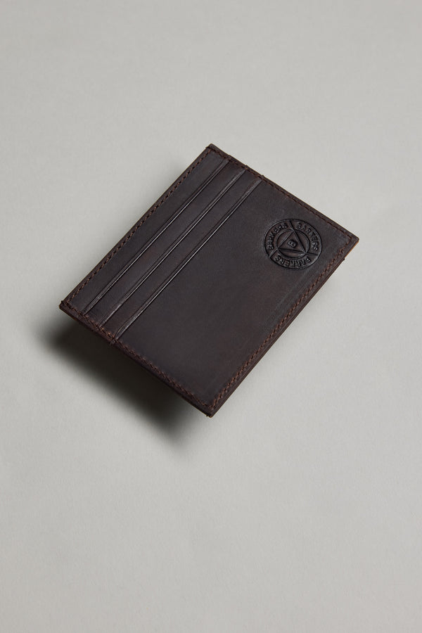 Barkers Taylor slim dark brown leather card wallet with logo, shown on a light gray surface.