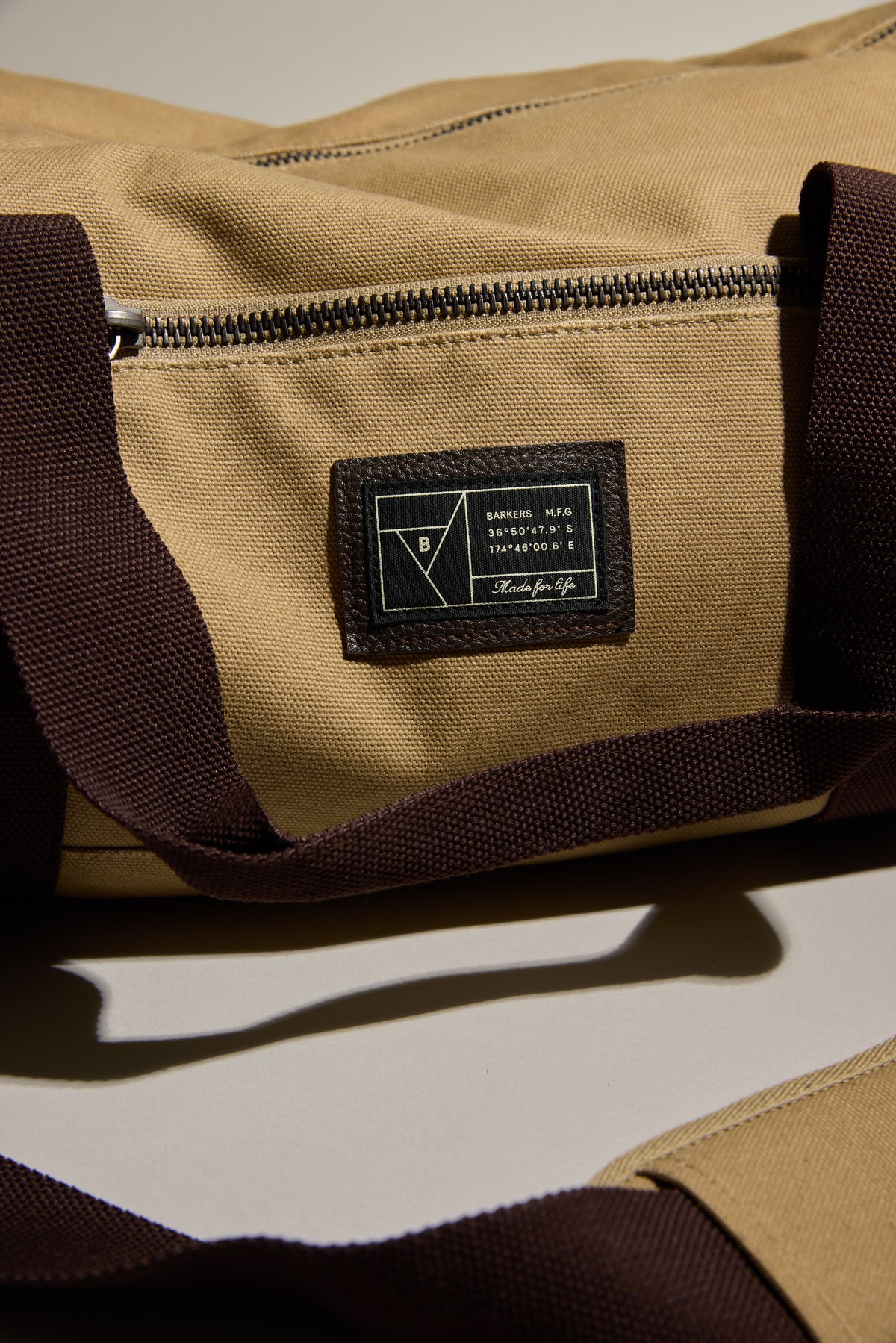 Barkers Canvas Duffle Bag: tan cotton canvas with dark brown straps—ideal for travel.