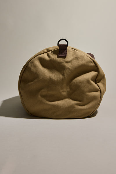 Barkers Canvas Duffle Bag: tan round cotton canvas with brown strap, perfect for travel.