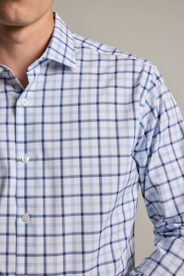 A close-up shows a person wearing the Barkers Wesley Check Business Shirt in light blue and white, featuring a collar. Only the lower face and upper torso appear against a neutral background.