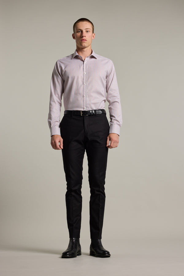 A man faces forward against a plain background, wearing the Barkers Marbury Check Business Shirt with a tailored fit, paired with black dress pants, a black belt, and black dress shoes.