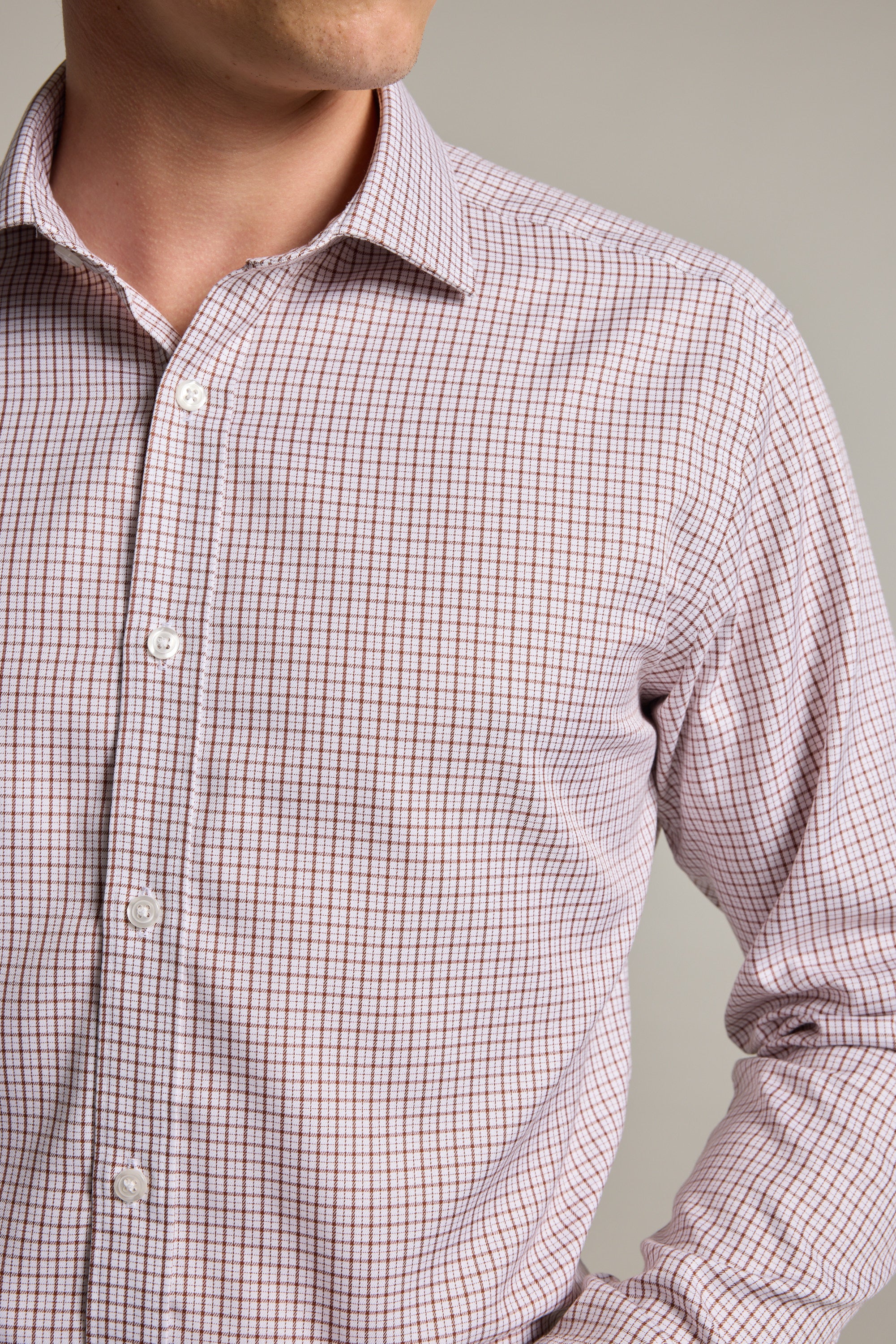 A man models the Barkers Marbury Check Business Shirt—a light-colored, long-sleeve, tailored fit shirt with a small check pattern—shown from chest to chin against a plain background.