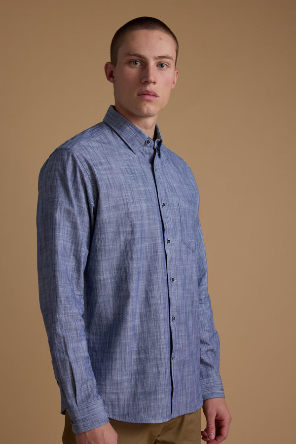 A young man with short hair wears the Barkers Blaine Stripe Shirt and beige pants, standing against a plain beige background and looking slightly to the side.