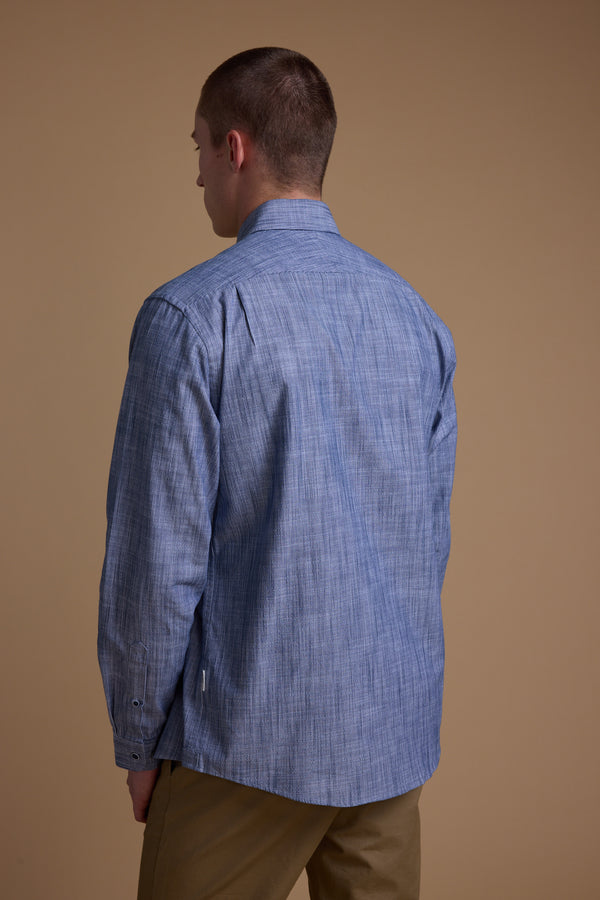 A man with short hair is seen from behind, wearing the Barkers Blaine Stripe Shirt in light blue and tan pants, standing against a plain beige background.