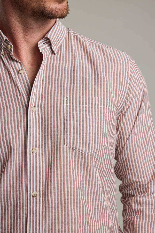 A man wears the Barkers Sumter Stripe Shirt—a tailored fit with light pink and white vertical stripes and a chest pocket; only his lower face and upper torso are visible.