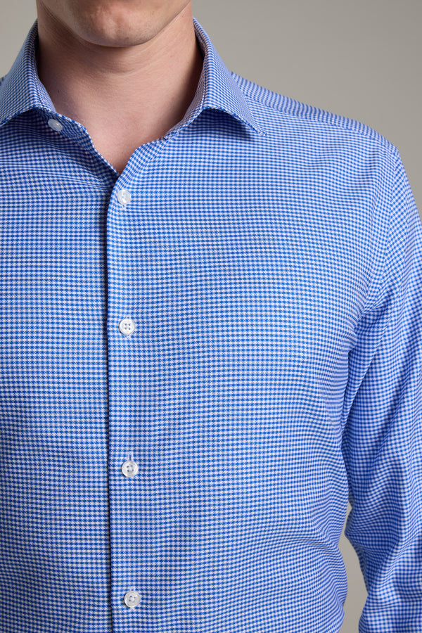 A person wears the Barkers Mitchel Check Business Shirt, featuring a blue and white check pattern and white buttons, shown from chin to waist against a plain gray background.