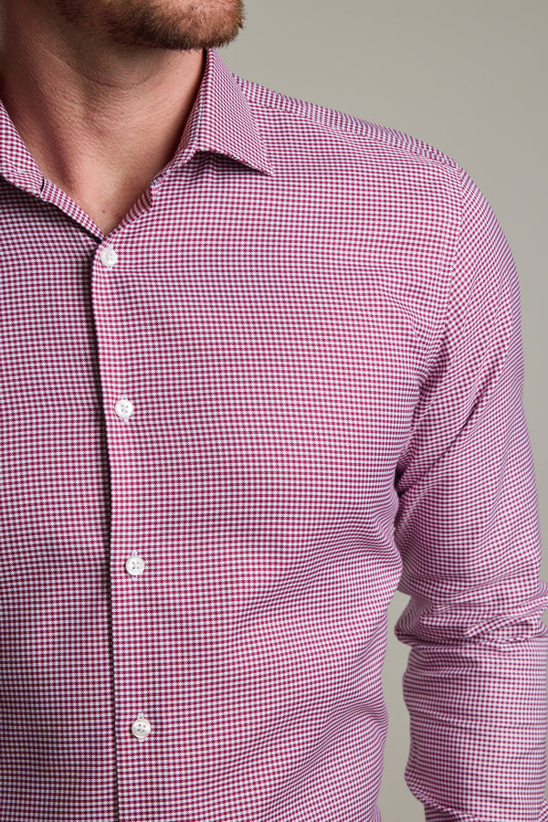 A close-up shows the lower face, neck, and upper torso of a person wearing Barkers' Mitchel Check Business Shirt—a tailored fit, long-sleeved shirt featuring a small red and white checkered pattern.
