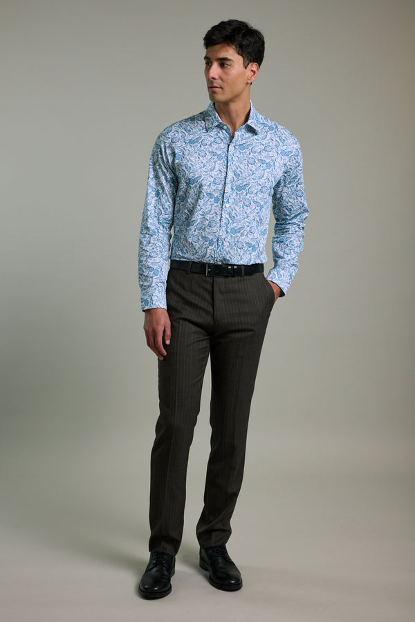 Man wears Barkers Ronton Print Business Shirt and dark trousers, one hand in his pocket.