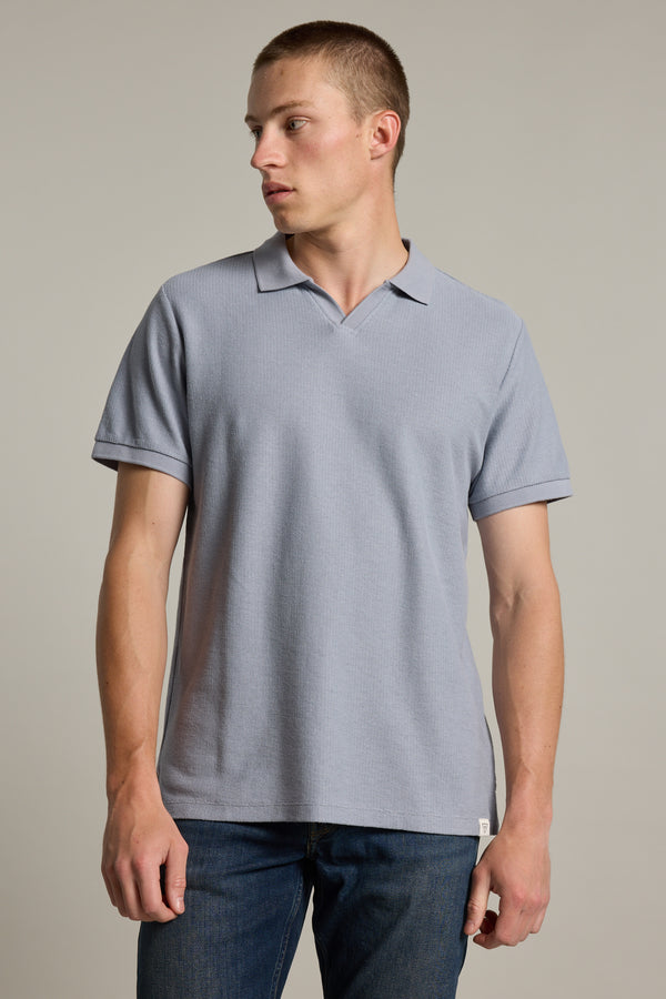 A man in a Barkers Winfield Textured Polo looks left against a plain background.