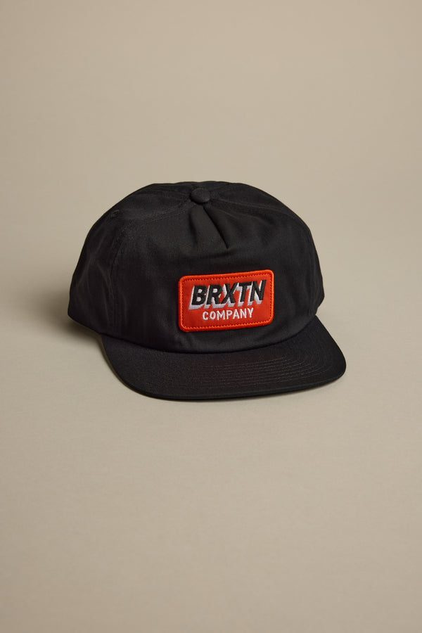 Black Brixton Payment MP Snapback with red and white logo patch on the front.