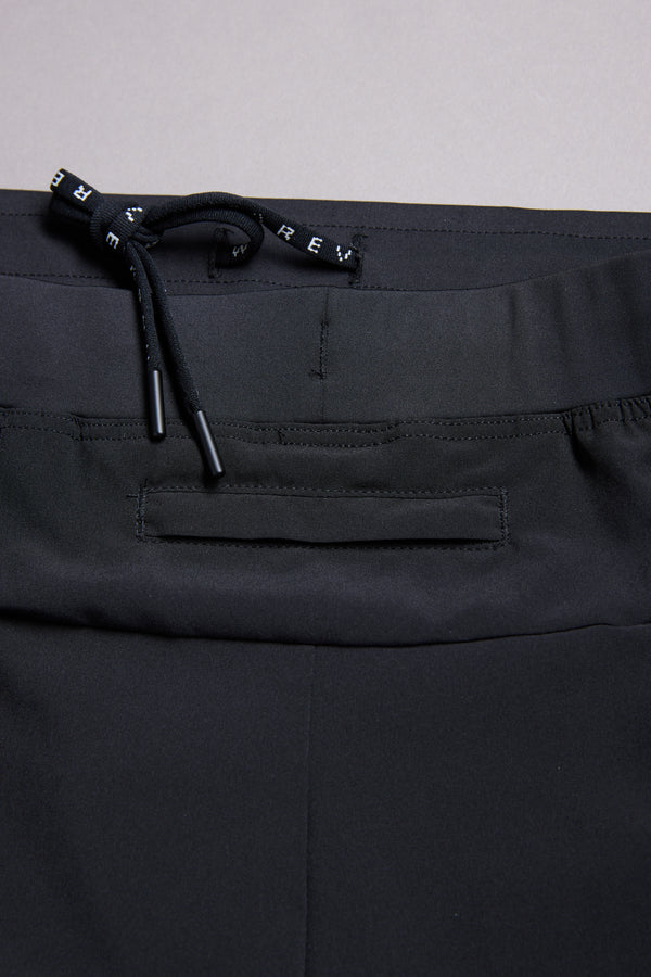 Close-up of the waistband and upper section of WearEver Cadence Short in black, featuring a drawstring and horizontal back pocket, set against a neutral background.
