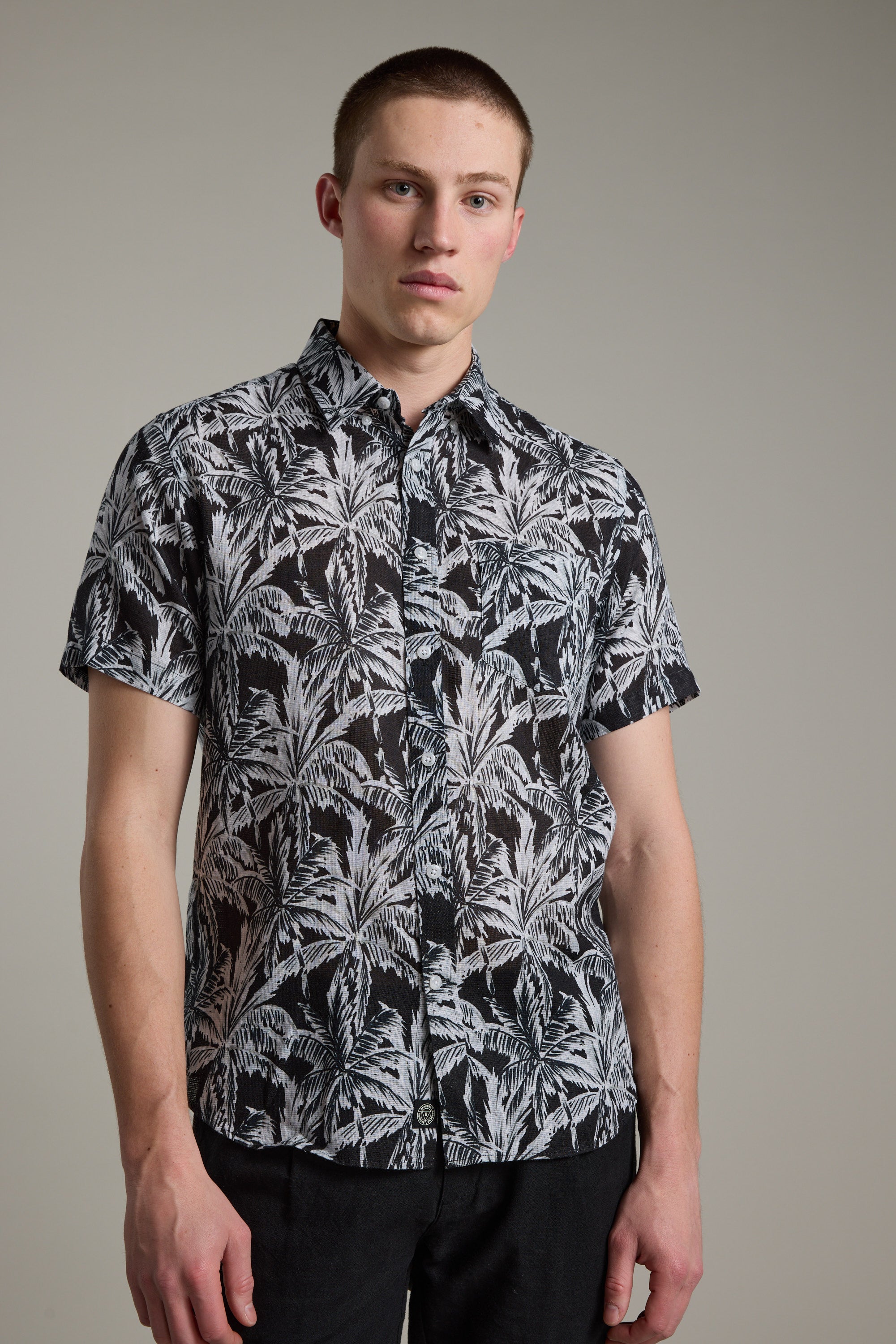 A man wearing the Barkers Madison Print Shirt, a black and white cotton–linen blend summer shirt.