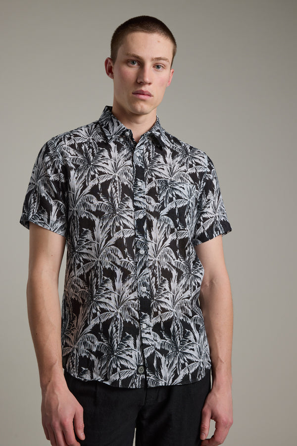 A man wearing the Barkers Madison Print Shirt, a black and white cotton–linen blend summer shirt.