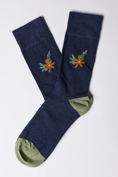 The Barkers Dalton Flower Sock features navy blue cotton blend fabric with light green toes and heels, plus a small orange and green floral detail near the cuff—an ideal gift for any flower lover.