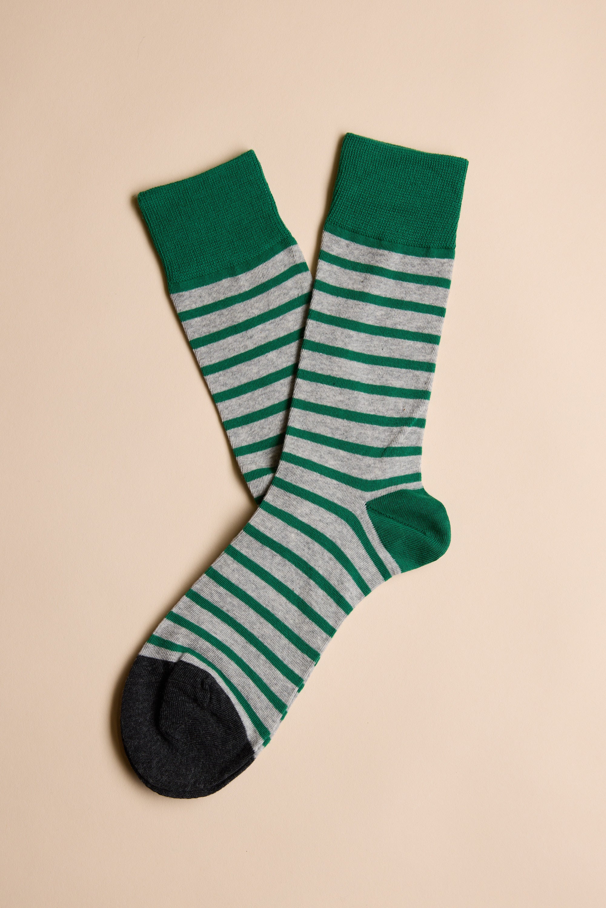 The Mojave Stripe Sock by Barkers is a gray cotton sock with green stripes, heels, toes, and cuffs—ideal for those seeking comfort and style.