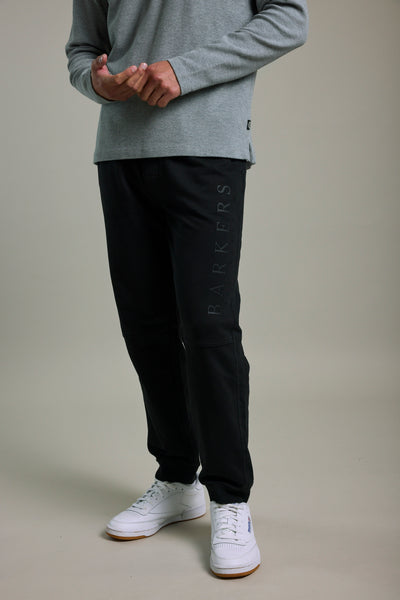 Person in a grey long-sleeve shirt, Barkers Organic Classic Print Track Pant, and white sneakers.