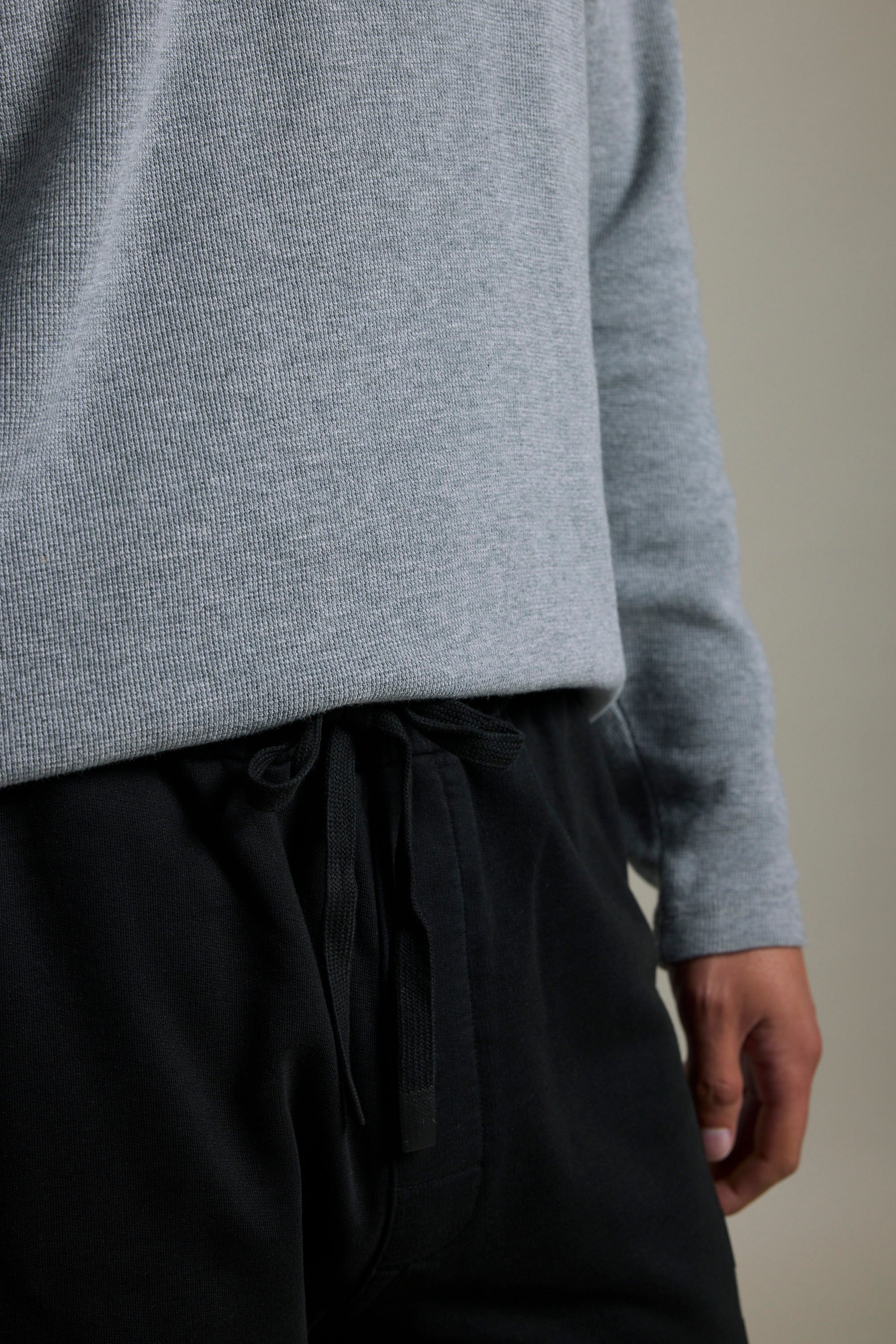 Person in a gray long-sleeve shirt and Barkers Organic Classic Print Track Pant.