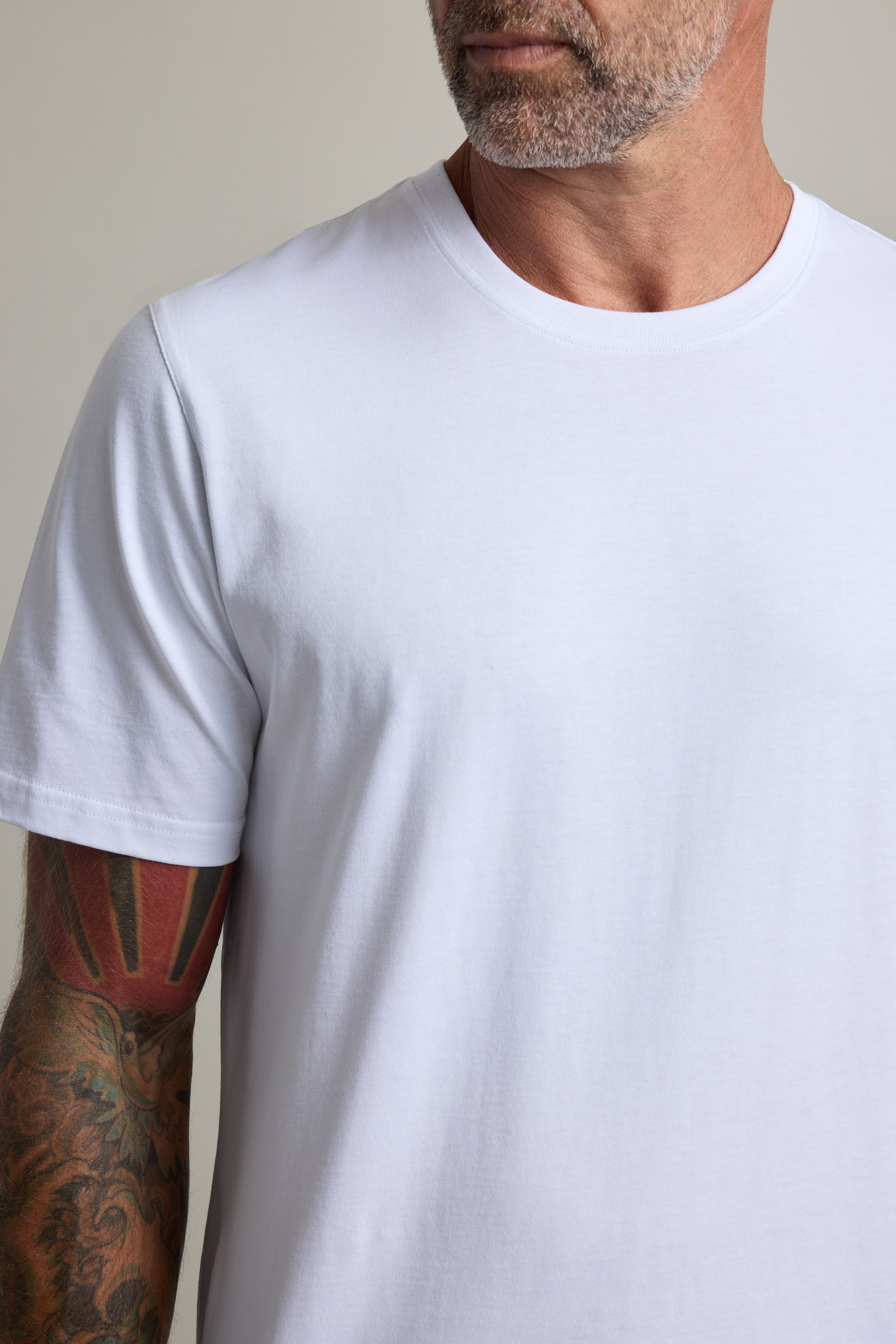Bearded man in Barkers Good Earth Cotton Essential Tee, traceable cotton, tattooed arm.