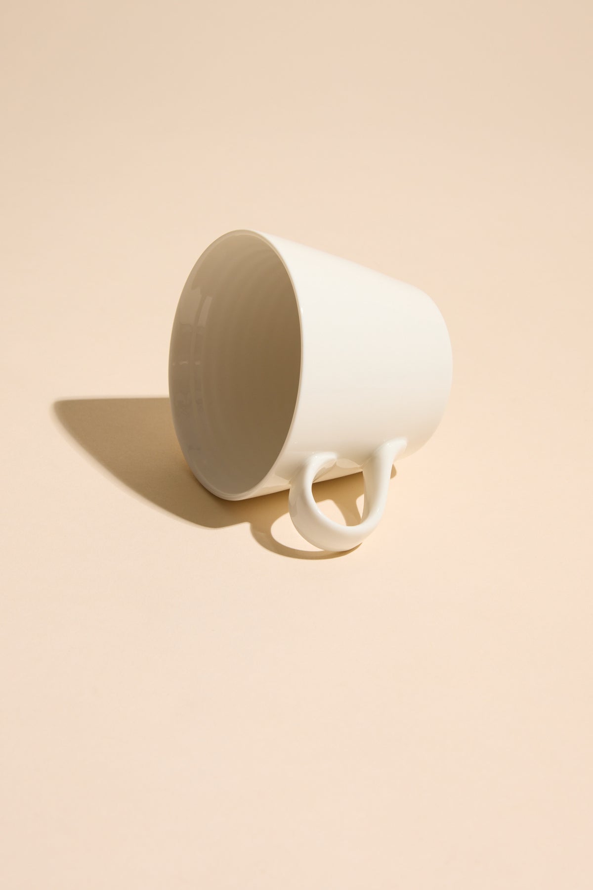 Other Bucket Mug - Old Fart rests sideways on beige, casting a clear shadow.