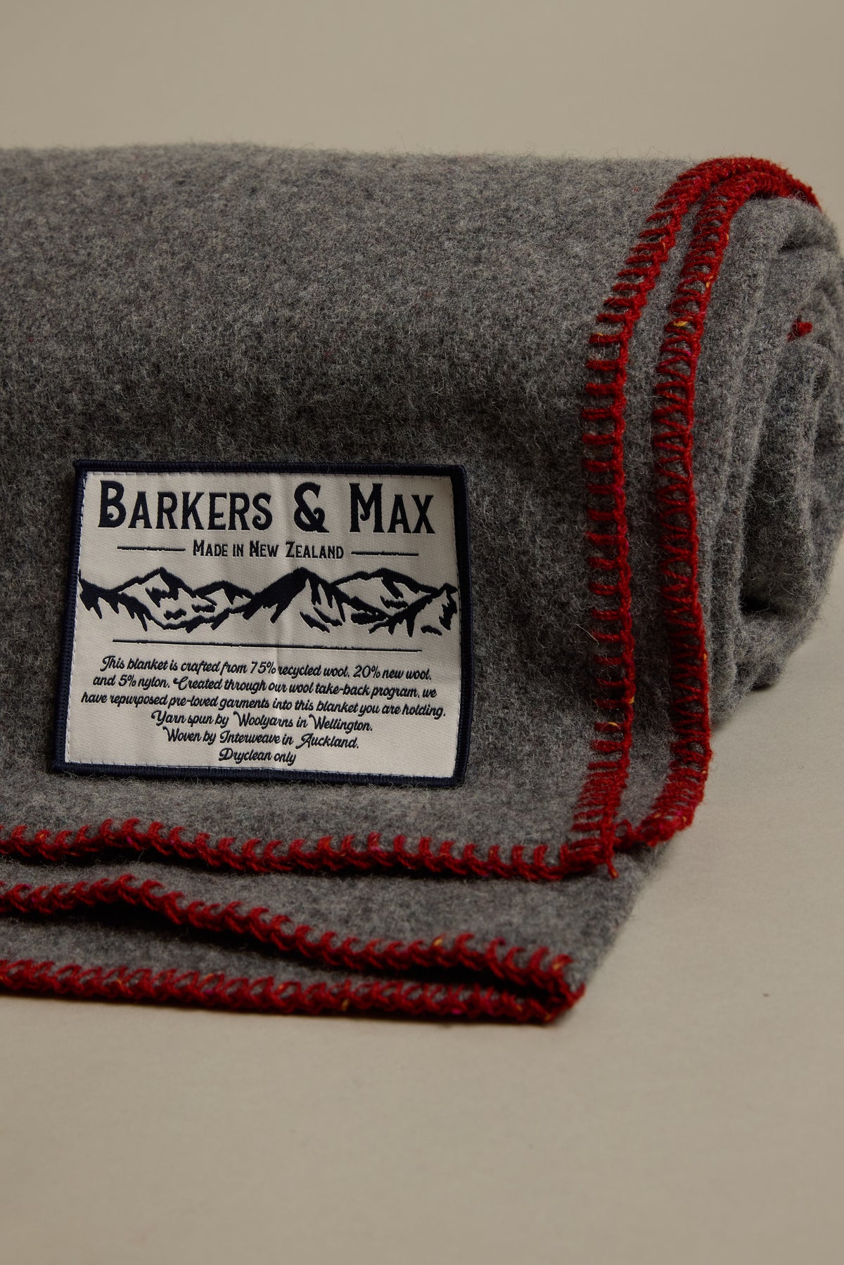 Gray Wool Take Back Blanket by Other with red trim and corner label.