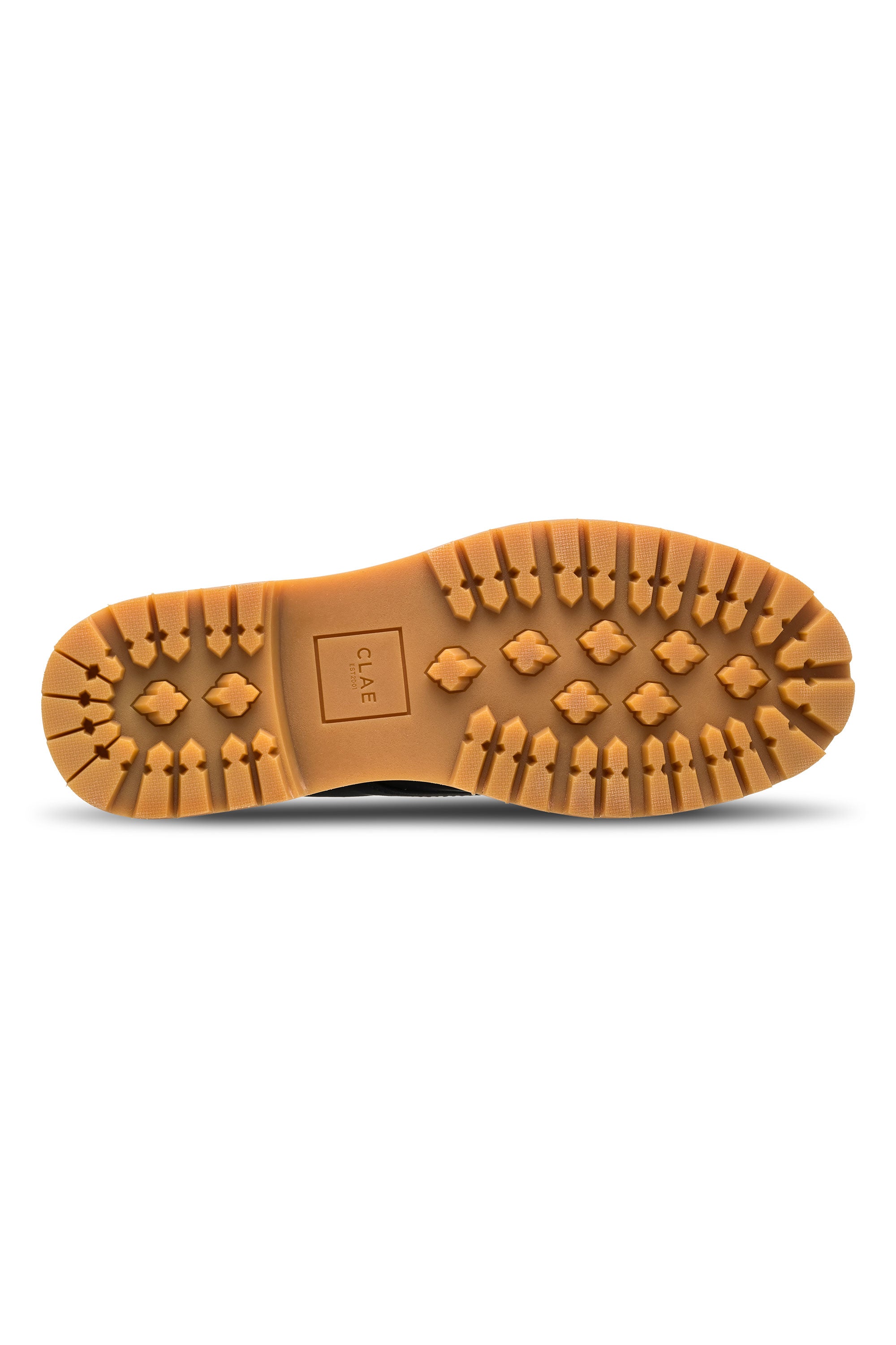 The image shows the bottom of a tan rubber shoe sole with deep cross and arrow treads. "CLAE" is embossed near the center, showcasing the Clae Logan’s quality design and craftsmanship.