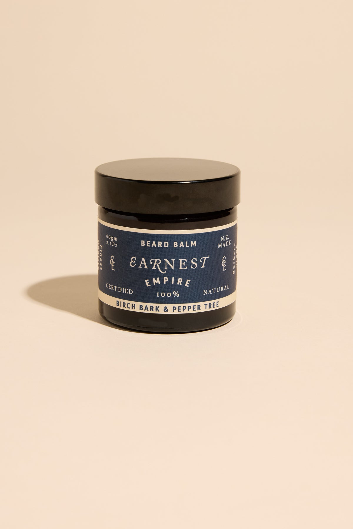 Other Earnest Empire Beard Balm, birch bark scent, displayed on a beige background.