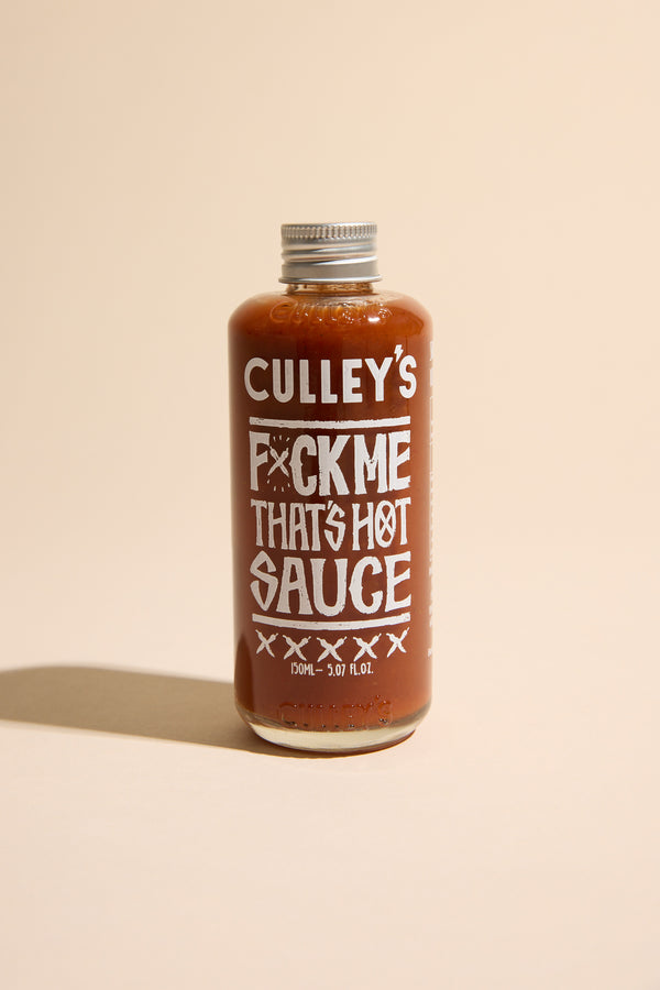 Culley’s F@#k Me That’s Hot Sauce bottle on a beige background.