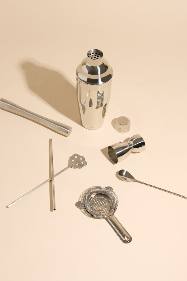 Society Paris Cocktail Mixologist Kit with shaker, strainer, jigger, and tools on beige.