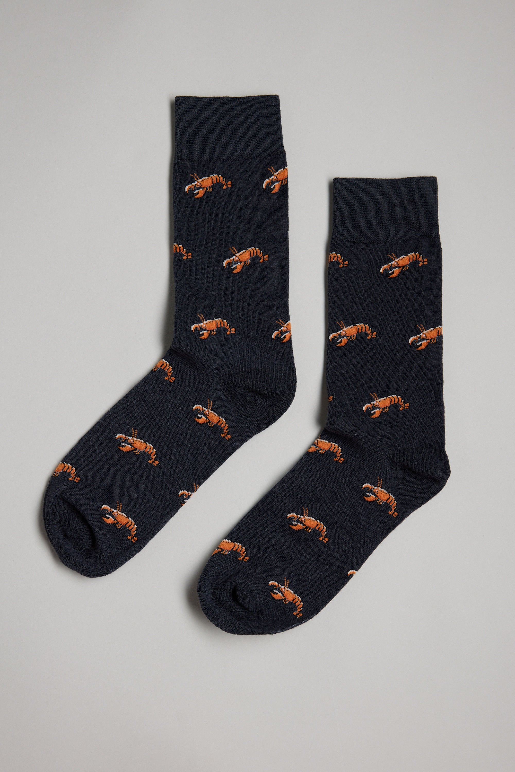 The Barkers Crayfish Sock features a dark navy cotton design with an all-over pattern of small orange crayfish—perfect as a gift for men.