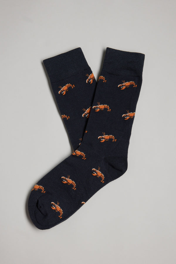 Barkers Crayfish Sock: navy blue cotton socks featuring an orange lobster pattern, laid overlapping on a light gray background. A fun and unique gift for men.