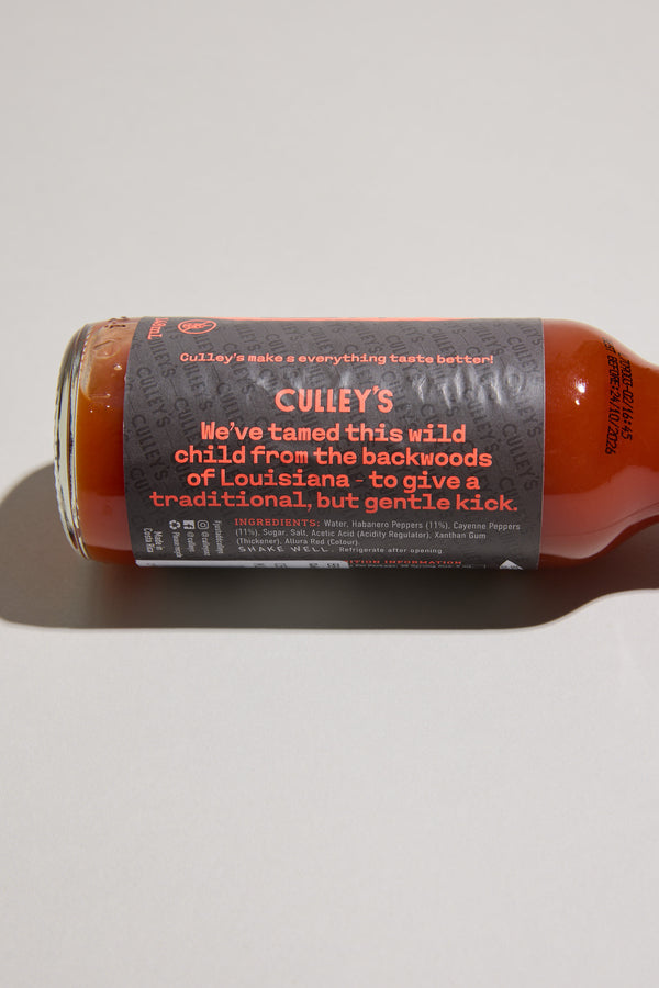 Culley’s Demure Habanero Hot Sauce bottle with dark label and bold text on its side.
