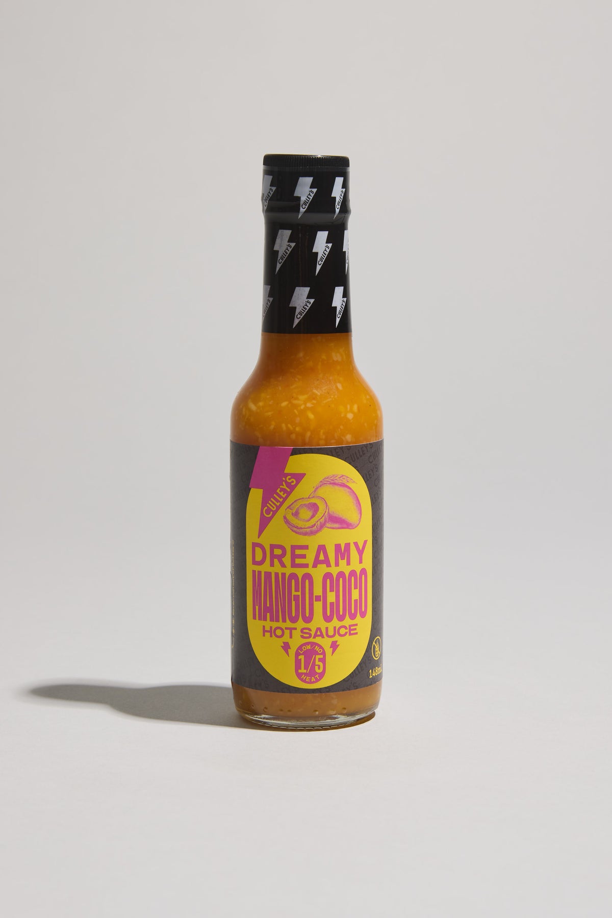 Culley’s Dreamy Mango-Coco Hot Sauce with a yellow and purple label on a light background.