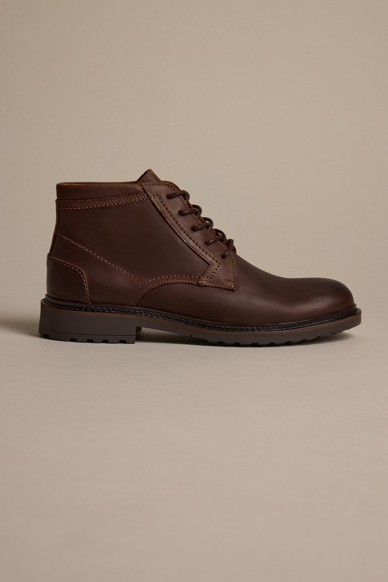 The Barkers Carlton Boot is a brown Italian leather lace-up ankle boot with a rugged sole, shown in profile on a neutral beige background.