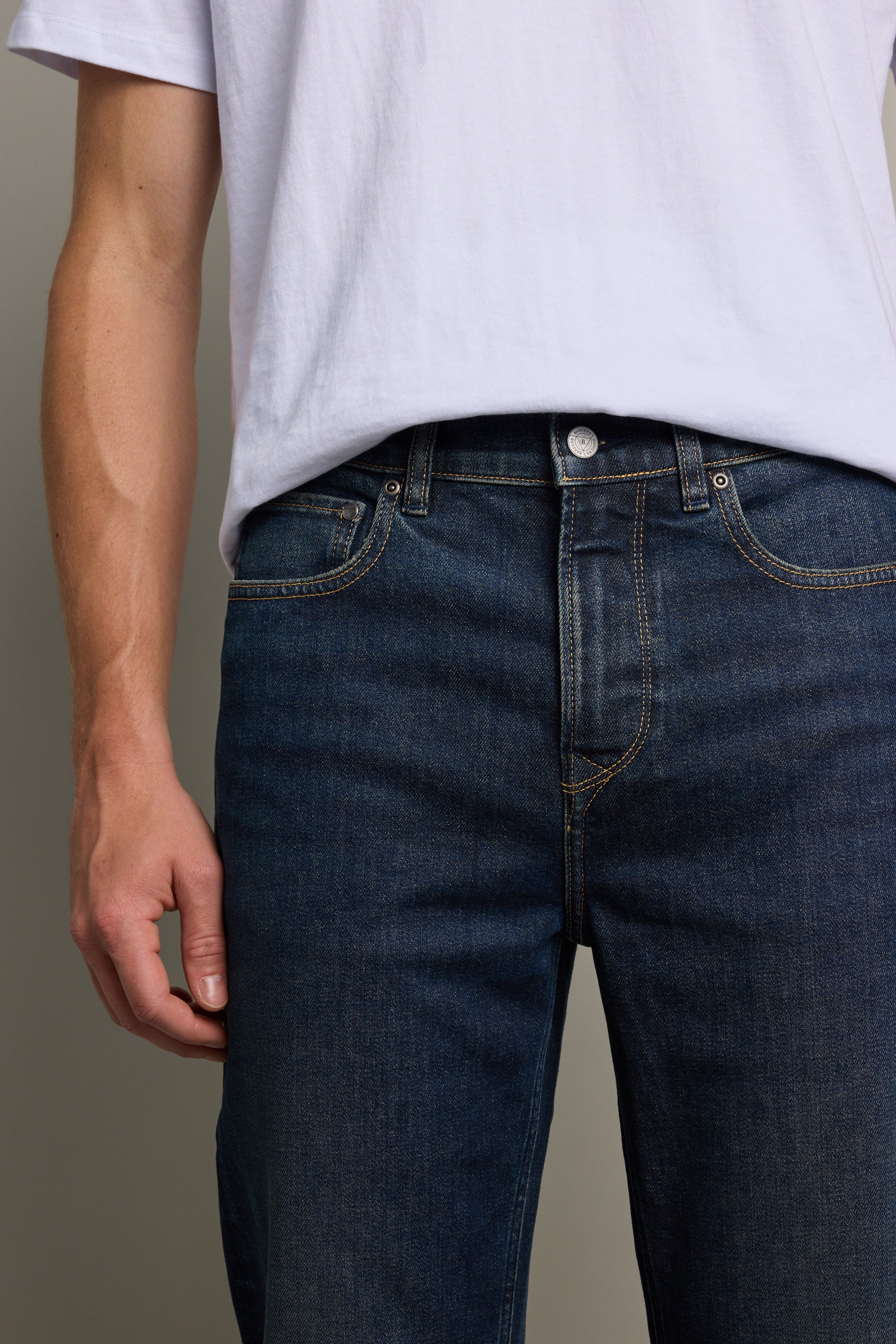 A person wearing a plain white T-shirt and Barkers Wanderer Denim Straight Jeans is shown from shoulders to thighs, with one arm relaxed by their side against a neutral background.