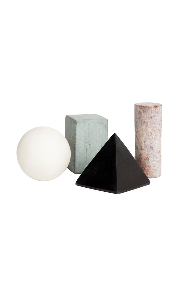 Four geometric shapes from Areaware Drink Rocks by Areaware: a white sphere, gray-green cube like whiskey stones, black pyramid, and pinkish cylindrical column on a white background.