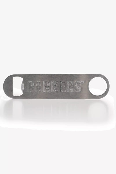 The Barkers Bottle Opener by Barkers is a metal bartender tool with “BARKERS” engraved, featuring a circular hole on one end and a bottle-opening slot on the other.
