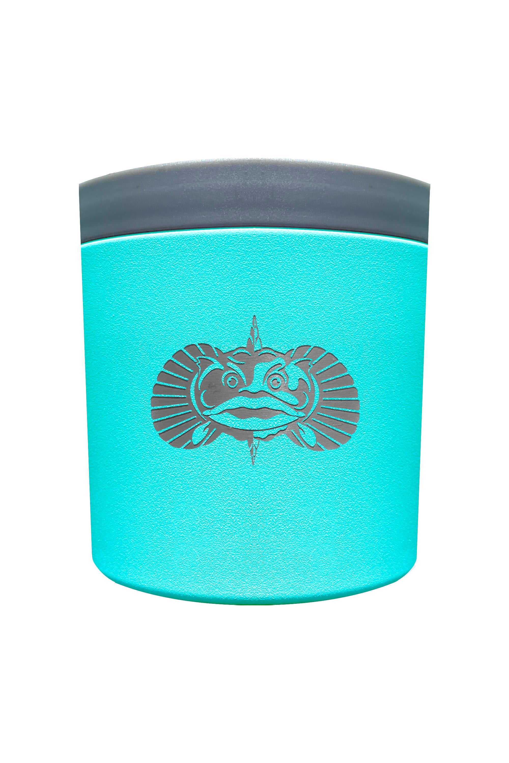 The Toadfish The Anchor is a turquoise cylindrical container with a gray lid and a black fish design. Featuring Smartgrip technology, this non-tipping cup holder by Toadfish stays secure on any surface. Shown against a plain white background.